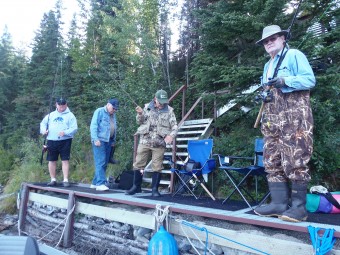 Mike, Tom, John, and Sherm getting their poles ready for a day of fishing.